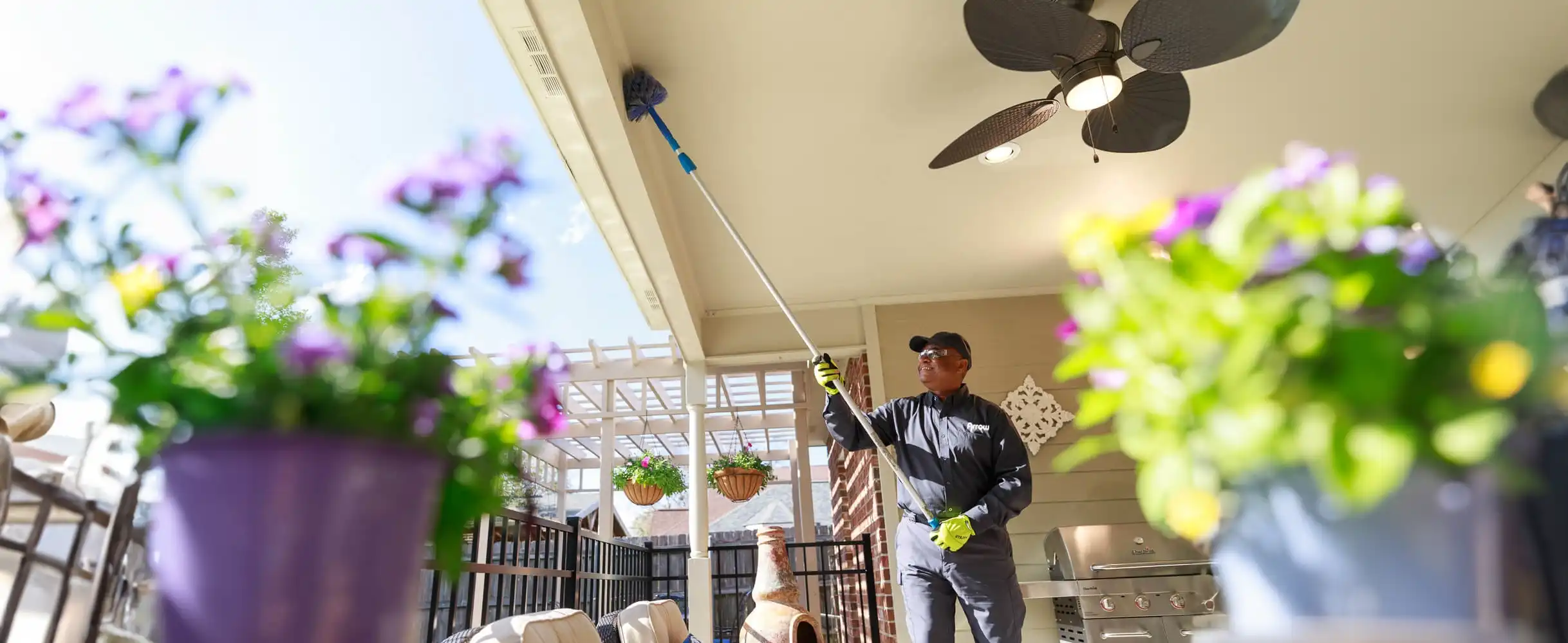 Pest control technician treating a patio - Keep pests away from your home with Arrow Services in FL