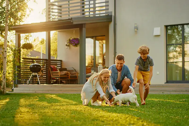 Family playing in backyard with dog