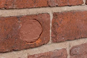 Hole in a brick wall sealed with Flexi Armour