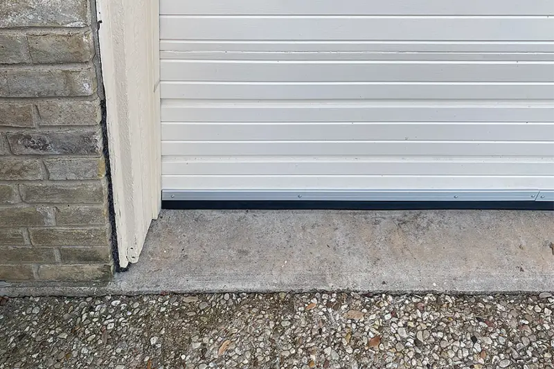 Arrow Environmental Services installing a heavy-duty Flexi-Armour garage door seal to provide a rodent-proof home barrier.
