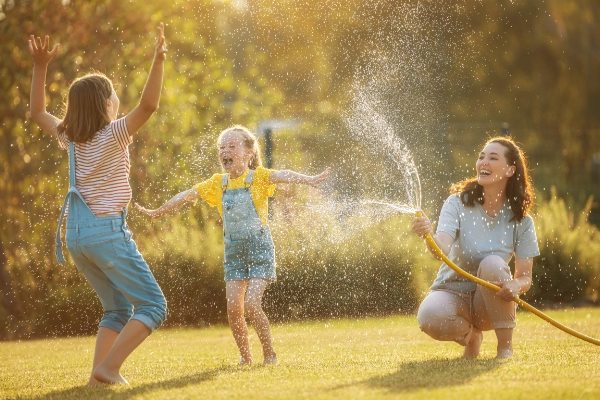 A family enjoying a mosquito-free Florida backyard, protected by the professional seasonal pest treatments of Arrow Environmental Services.